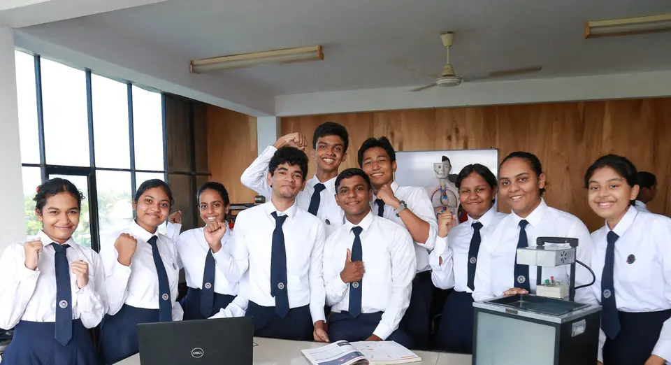 A group of older pupils in white shirts and ties smile together in a science room.